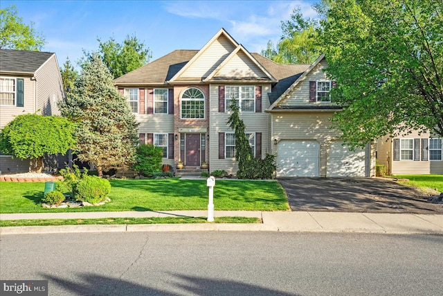 420 Highlands Blvd, Easton, PA 18042 - colonial house with asphalt driveway, a garage, and a front yard