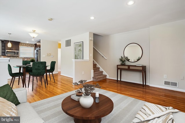 5100 12th St NE, Washington, DC 20011 - living room featuring light wood-style floors, stairway, and recessed lighting