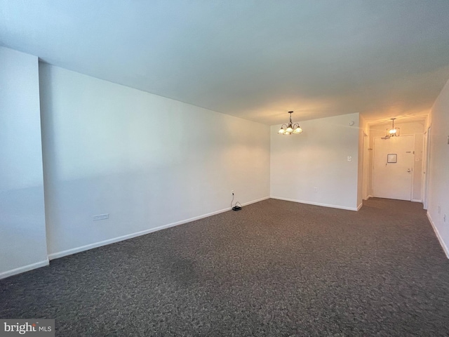 2939 Van Ness St NW Unit 743, Washington, DC 20008 - spare room with a chandelier and dark colored carpet
