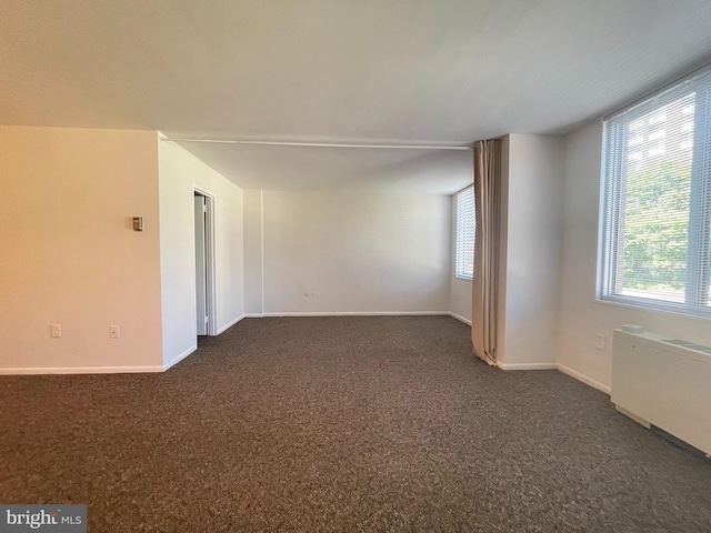2939 Van Ness St NW Unit 743, Washington, DC 20008 - unfurnished room featuring radiator, dark colored carpet, and healthy amount of natural light