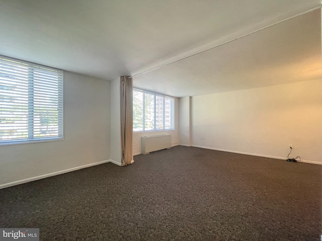 2939 Van Ness St NW Unit 743, Washington, DC 20008 - empty room with radiator heating unit and dark colored carpet