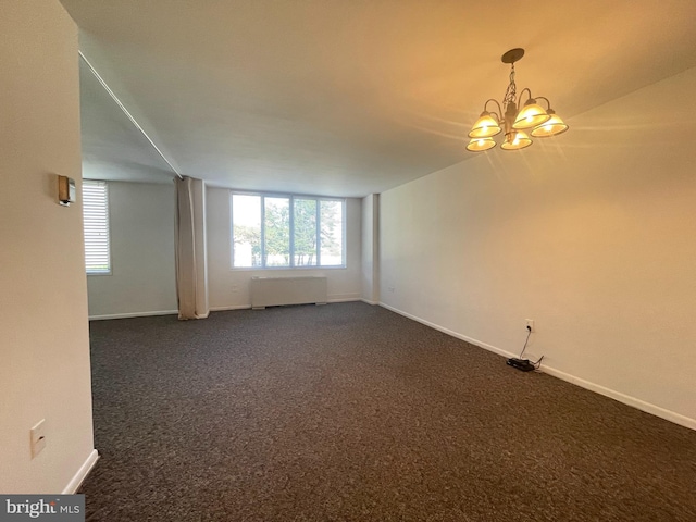 2939 Van Ness St NW Unit 743, Washington, DC 20008 - unfurnished room with radiator, dark carpet, and a chandelier