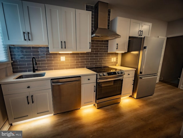 7127 Woolston Ave, Philadelphia, PA 19138 - kitchen with appliances with stainless steel finishes, wall chimney exhaust hood, light wood-type flooring, and light countertops