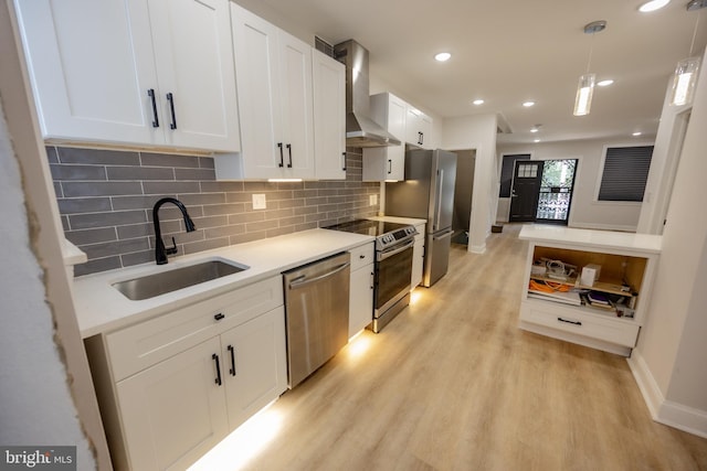 7127 Woolston Ave, Philadelphia, PA 19138 - kitchen with stainless steel appliances, wall chimney exhaust hood, white cabinets, light wood-style floors, and recessed lighting