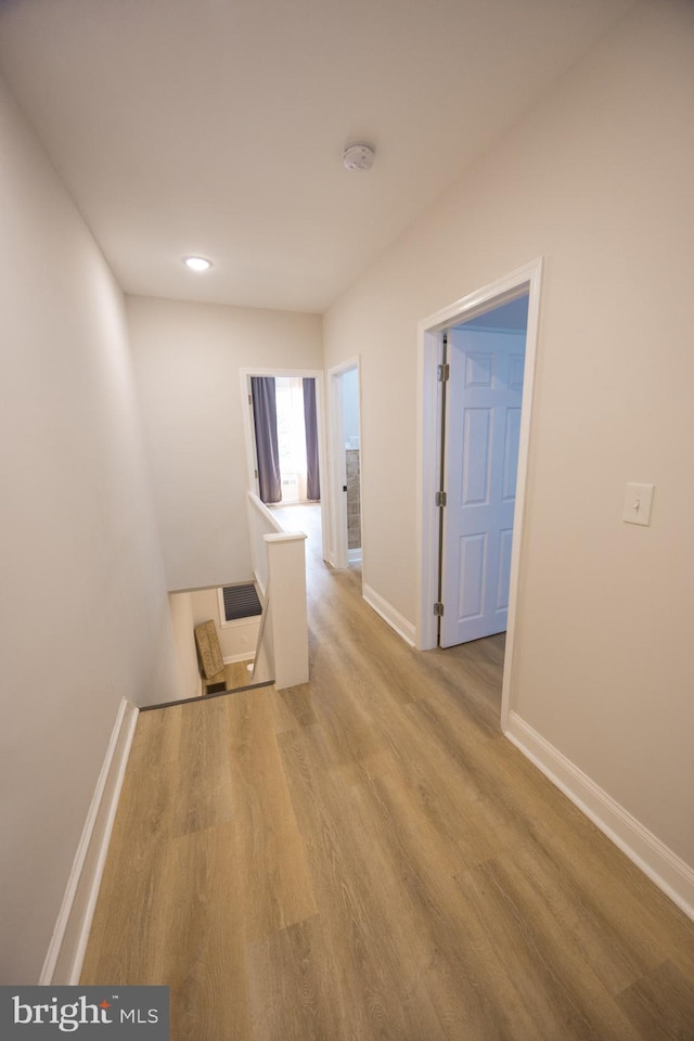 7127 Woolston Ave, Philadelphia, PA 19138 - hallway with wood finished floors and an upstairs landing