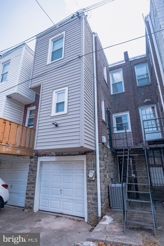 7127 Woolston Ave, Philadelphia, PA 19138 - back of property with a garage and stone siding