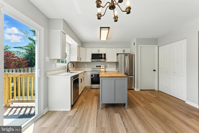 3159 Benton Square Dr, Olney, MD 20832 - kitchen featuring stainless steel appliances, butcher block countertops, light wood finished floors, a kitchen island, and a chandelier