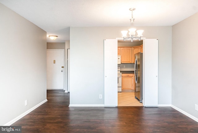 307 Yoakum Pkwy Unit 716, Alexandria, VA 22304 - kitchen with white appliances, a chandelier, light brown cabinetry, light wood-style flooring, and hanging light fixtures
