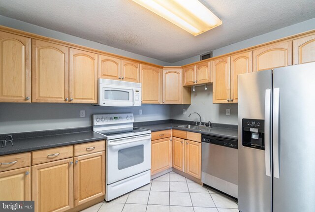 307 Yoakum Pkwy Unit 716, Alexandria, VA 22304 - kitchen with stainless steel appliances, light brown cabinetry, and a textured ceiling
