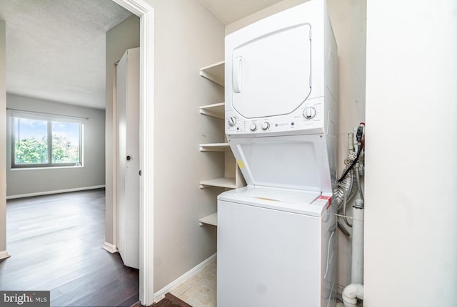 307 Yoakum Pkwy Unit 716, Alexandria, VA 22304 - laundry area featuring stacked washer / dryer and wood finished floors