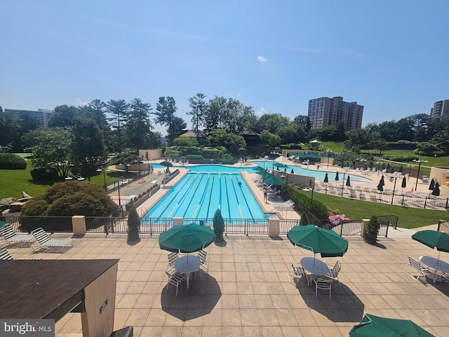 307 Yoakum Pkwy Unit 716, Alexandria, VA 22304 - community pool featuring a patio area and view of scattered trees