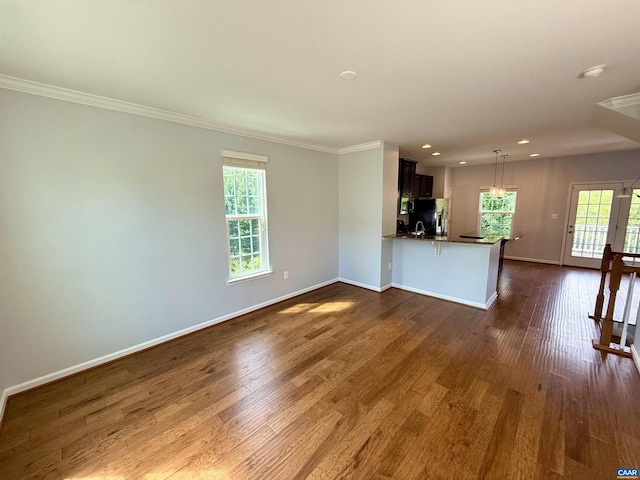 2176 Whispering Hollow Ln, Charlottesville, VA 22911 - unfurnished living room featuring dark wood-type flooring, crown molding, plenty of natural light, and recessed lighting