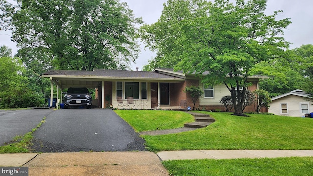 12912 Middlevale Ln, Silver Spring, MD 20906 - view of front of property with a front yard, driveway, brick siding, and a carport