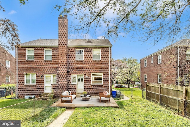11944 Andrew St, Silver Spring, MD 20902 - back of property with a fenced backyard, a chimney, a patio area, brick siding, and an outdoor living space