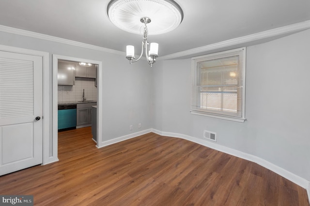 1112 Serrill Ave, Lansdowne, PA 19050 - unfurnished room featuring dark wood finished floors, ornamental molding, and a chandelier