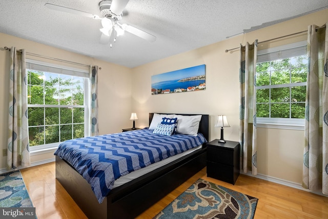 1533 Lincoln Way Unit 301A, Mclean, VA 22102 - bedroom with light wood finished floors, a textured ceiling, and a ceiling fan