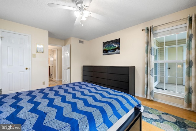 1533 Lincoln Way Unit 301A, Mclean, VA 22102 - bedroom with wood finished floors, ceiling fan, and a textured ceiling
