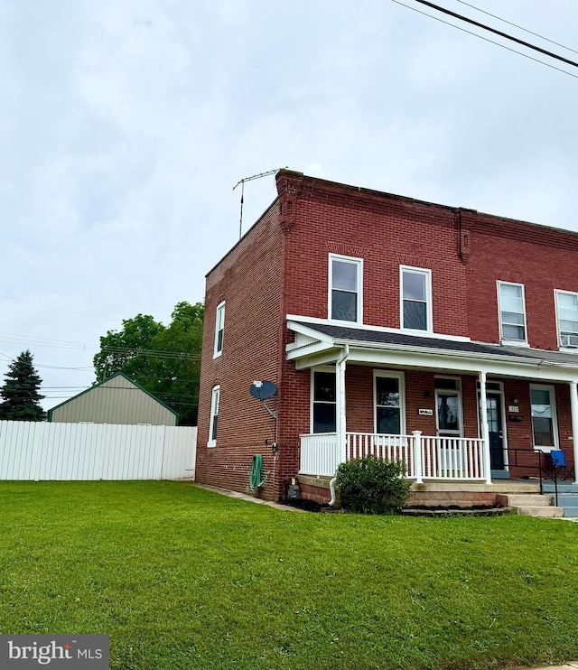325 Pine St, Hanover, PA 17331 - view of front of home with brick siding, covered porch, and a front lawn