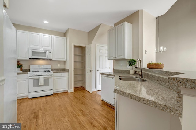 13854 Cinch Ln, Gainesville, VA 20155 - kitchen with white appliances, light wood-style floors, white cabinetry, recessed lighting, and a chandelier