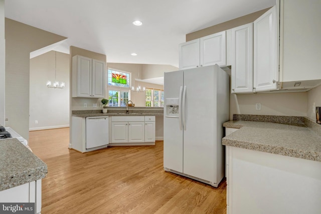13854 Cinch Ln, Gainesville, VA 20155 - kitchen featuring white appliances, light wood-style floors, a chandelier, white cabinetry, and light countertops