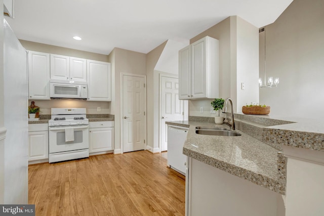 13854 Cinch Ln, Gainesville, VA 20155 - kitchen with white appliances, white cabinets, light wood finished floors, recessed lighting, and a chandelier