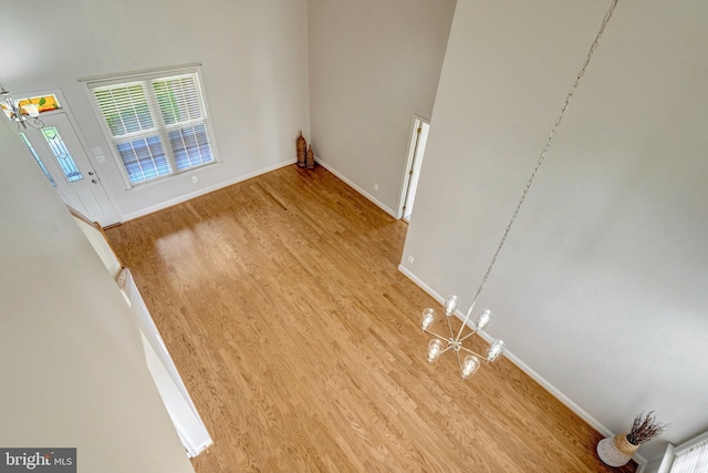 13854 Cinch Ln, Gainesville, VA 20155 - unfurnished room featuring wood finished floors and a chandelier
