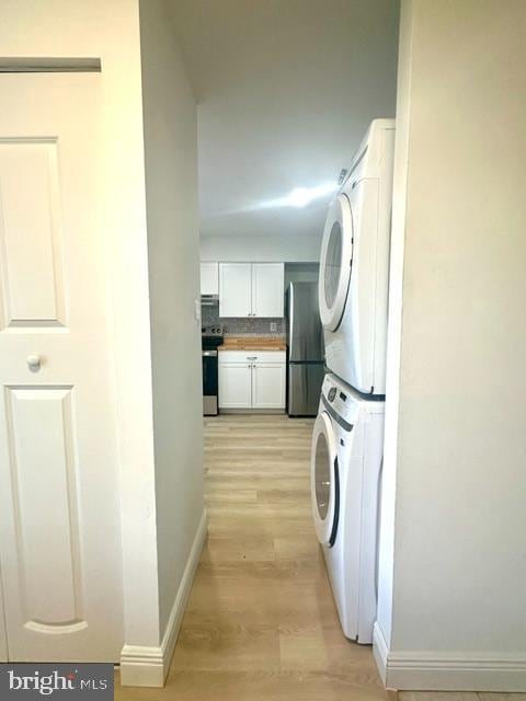 7851 W Point Ct, Manassas, VA 20109 - laundry area with estacked washer and dryer and light wood-style flooring