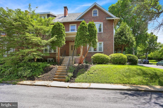 23 Trebor Pl, Reading, PA 19610 - view of front facade with brick siding, a chimney, stairs, and a porch