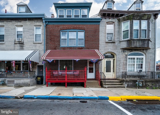 930 Elm St, Reading, PA 19601 - view of property featuring brick siding, cooling unit, and uncovered parking