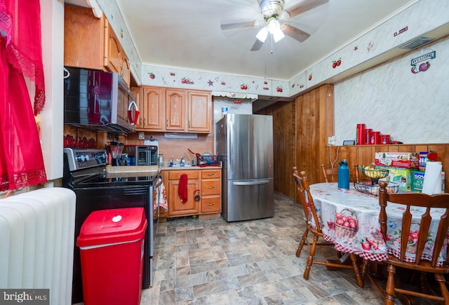 930 Elm St, Reading, PA 19601 - kitchen with stainless steel appliances, radiator, ceiling fan, and brown cabinetry