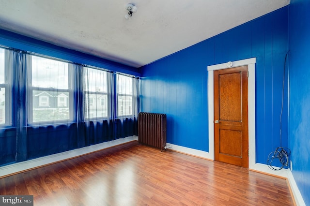 930 Elm St, Reading, PA 19601 - unfurnished room with radiator heating unit and wood finished floors