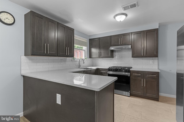 3647 Friar Rd, Philadelphia, PA 19154 - kitchen with stainless steel gas range oven, under cabinet range hood, tasteful backsplash, and a peninsula