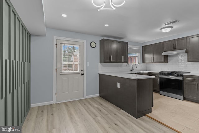 3647 Friar Rd, Philadelphia, PA 19154 - kitchen with stainless steel gas range, under cabinet range hood, backsplash, light countertops, and recessed lighting