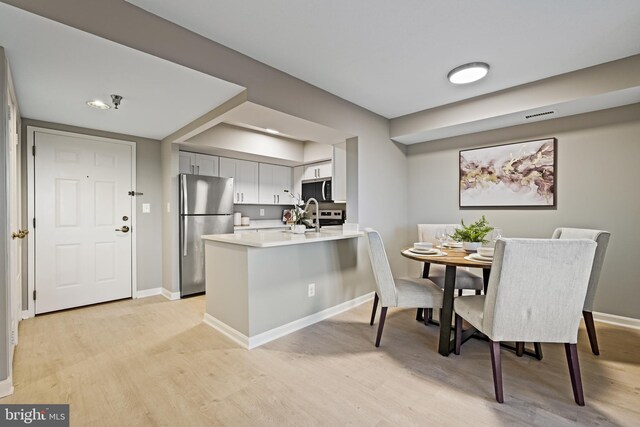 2400 Clarendon Blvd Unit 811, Arlington, VA 22201 - dining space with light wood-style flooring and baseboards