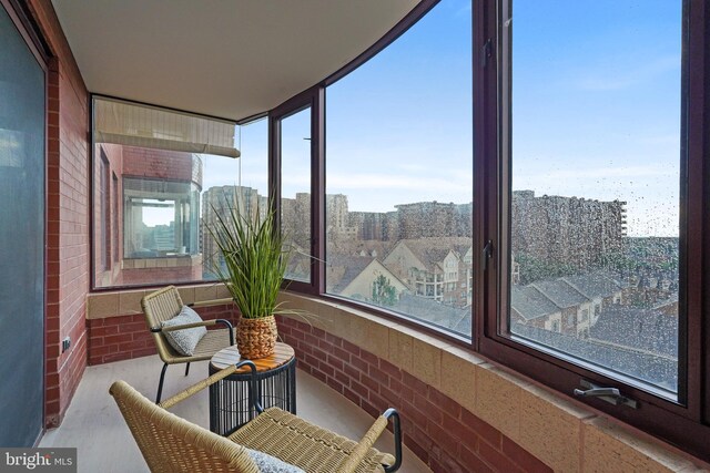 2400 Clarendon Blvd Unit 811, Arlington, VA 22201 - sunroom featuring brick wall