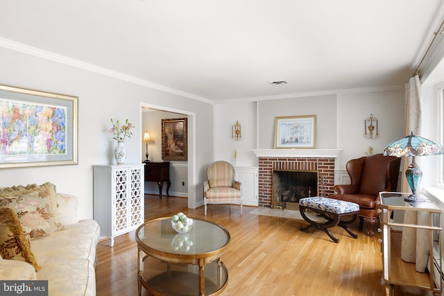 1512 Marsh Rd, Wilmington, DE 19803 - living room with wood finished floors, ornamental molding, and a brick fireplace