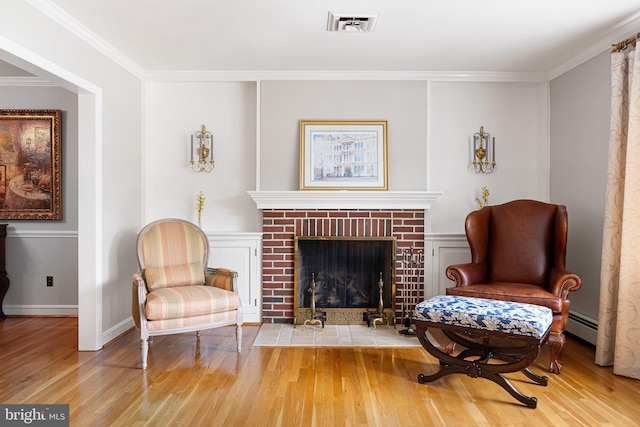 1512 Marsh Rd, Wilmington, DE 19803 - sitting room with wood finished floors, ornamental molding, baseboard heating, and a brick fireplace
