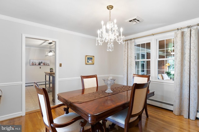1512 Marsh Rd, Wilmington, DE 19803 - dining area featuring light wood-style flooring, ornamental molding, baseboard heating, and a chandelier