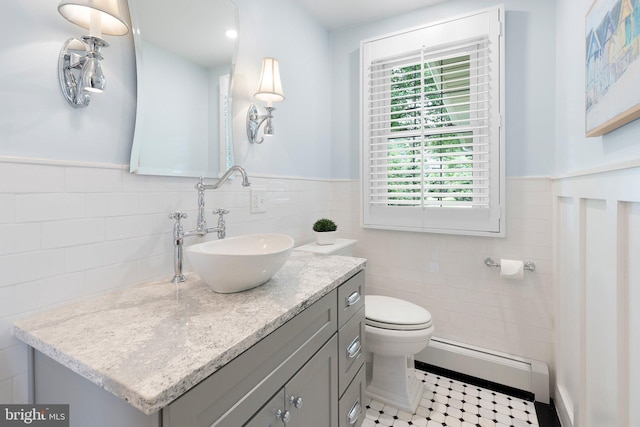1512 Marsh Rd, Wilmington, DE 19803 - bathroom with a baseboard radiator, vanity, tile walls, and wainscoting