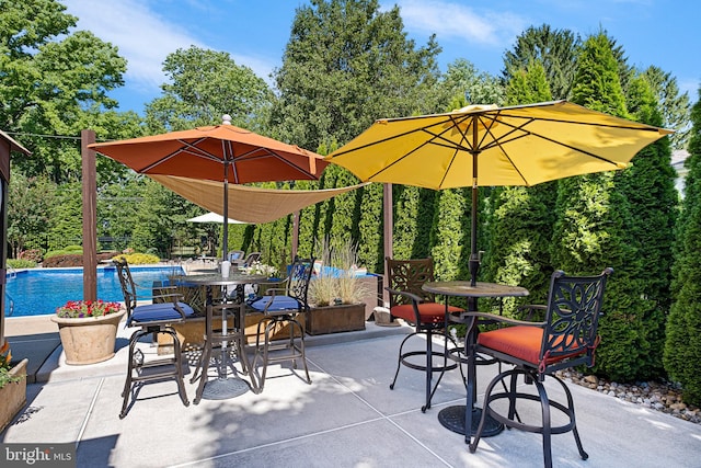 1512 Marsh Rd, Wilmington, DE 19803 - view of patio featuring an outdoor pool, outdoor dining area, and view of scattered trees