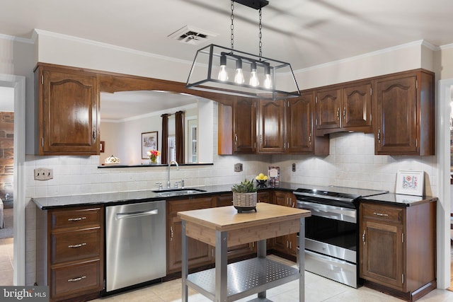1512 Marsh Rd, Wilmington, DE 19803 - kitchen with appliances with stainless steel finishes, dark countertops, light tile patterned floors, decorative backsplash, and crown molding