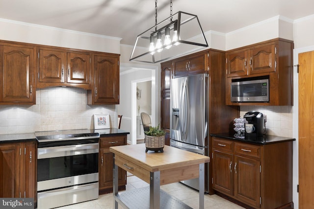 1512 Marsh Rd, Wilmington, DE 19803 - kitchen featuring stainless steel appliances, dark countertops, decorative backsplash, light tile patterned floors, and crown molding