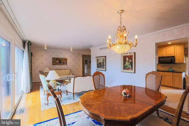 7119 Pheasant Cross Dr, Baltimore, MD 21209 - dining space with wallpapered walls, a chandelier, ornamental molding, and light wood-type flooring
