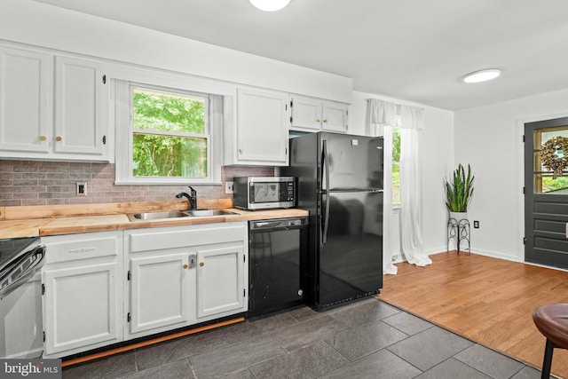 7918 Wicker Ln, La Plata, MD 20646 - kitchen featuring black appliances, white cabinetry, and backsplash