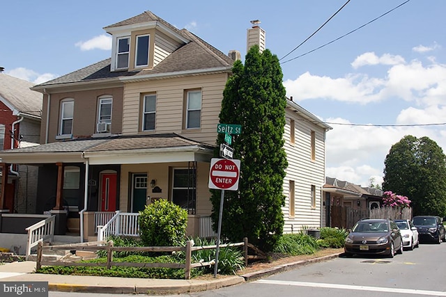 736 Seitz St, Easton, PA 18042 - view of front of house with a porch, a chimney, and roof with shingles