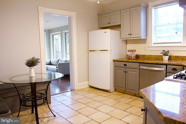 736 Seitz St, Easton, PA 18042 - kitchen with freestanding refrigerator, dishwasher, light tile patterned floors, and stone countertops