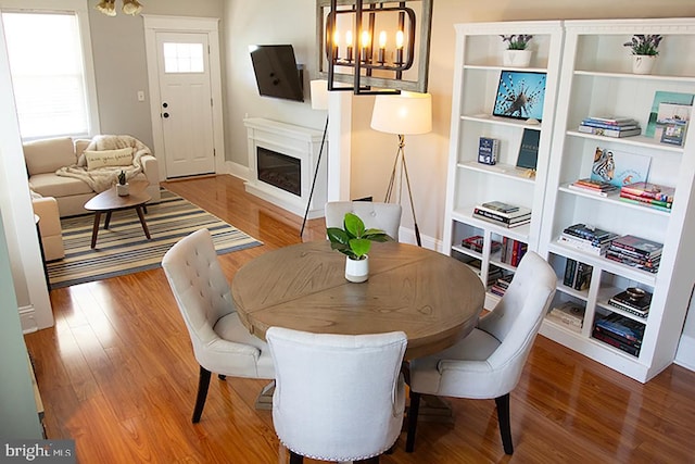 736 Seitz St, Easton, PA 18042 - dining space featuring a chandelier, wood finished floors, and a glass covered fireplace