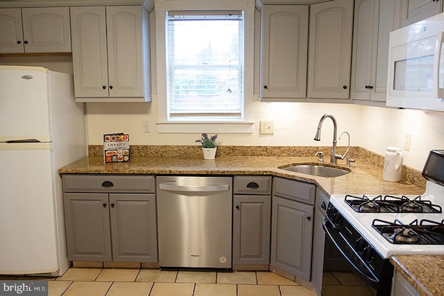 736 Seitz St, Easton, PA 18042 - kitchen with white appliances, gray cabinetry, light tile patterned floors, and light stone counters