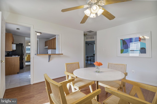 925 Barron Ave, Baltimore, MD 21221 - dining area with ceiling fan and light wood-style floors