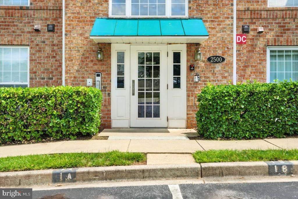 2500 Driftwood Ct Unit 3B, Frederick, MD 21702 - view of exterior entry featuring brick siding and a metal roof